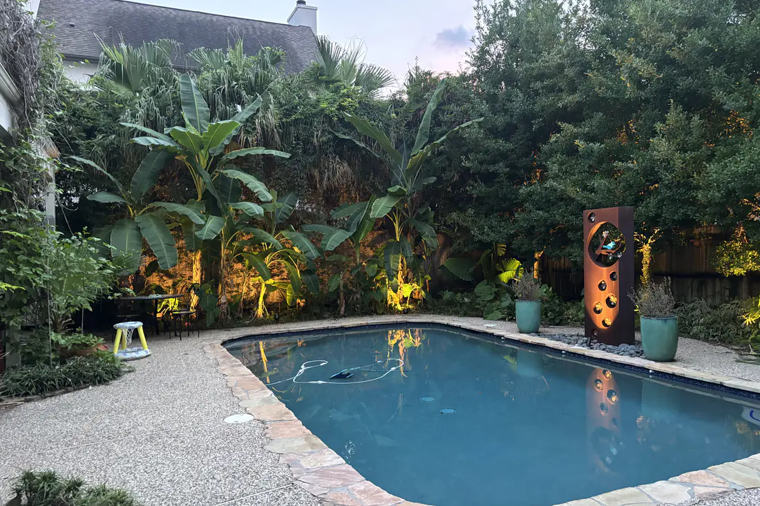 Pool and garden at blue hour lit with low-voltage landscape uplighting