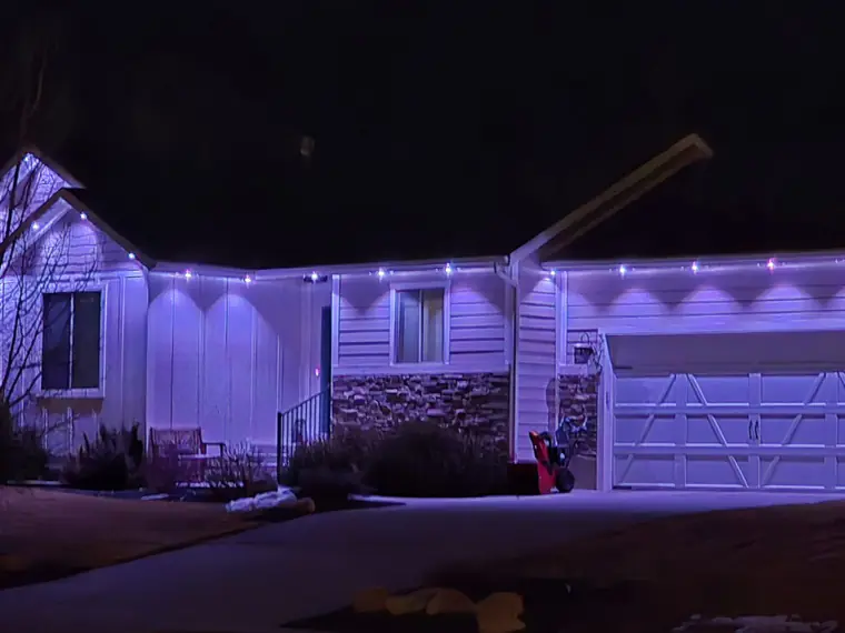 Home roofline outlined with colour-changing permanent lighting